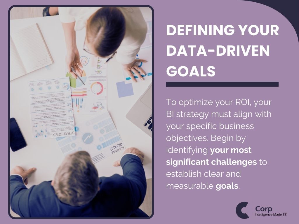 Team defining BI strategy and data-driven goals around a table with charts.