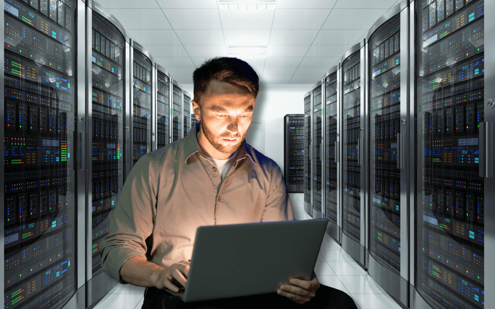 A person using a laptop in a server room with illuminated racks. The image emphasizes private cloud computing solutions, showcasing secure and efficient infrastructure for managing data and applications.