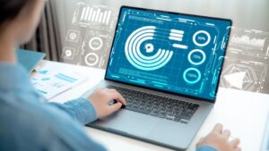 Professional analyzing BI dashboard on laptop with analytics charts and metrics, demonstrating business intelligence ROI turning data strategy into measurable value.