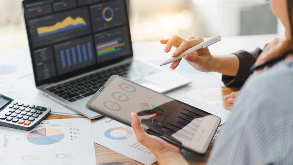 Finance professionals analyzing bad data on multiple devices and dashboards showing hidden financial damage and decision impact